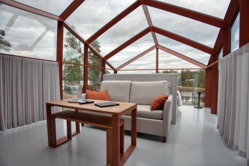 a living room with a couch and a table at Lunar Igloos - Ruska - Ellivuori Resort in Karkku