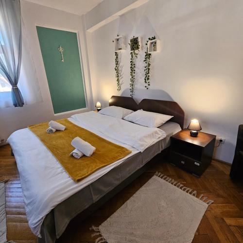 a bedroom with a large bed with towels on it at Apartment Zarnesti City Centre VMP Free Parking in Zărneşti