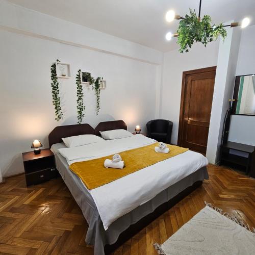 a bedroom with a large bed with towels on it at Apartment Zarnesti City Centre VMP Free Parking in Zărneşti