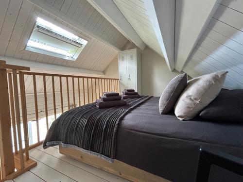 a bedroom with a large bed with pillows on it at Studio Veerse Meer in Wolphaartsdijk