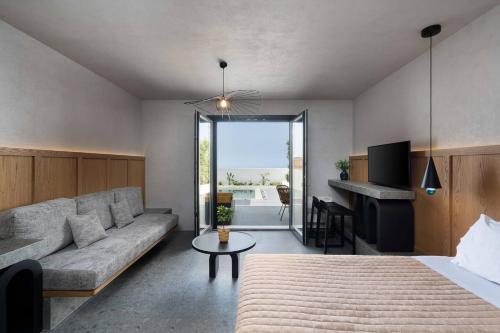 a living room with a couch and a table at La Torretta Suites & Spa in Pirgos
