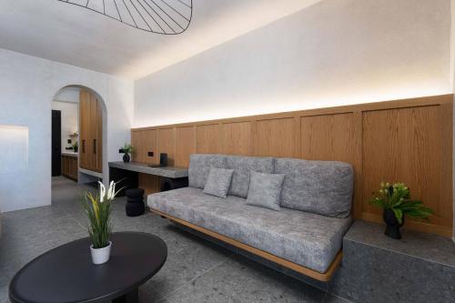 a living room with a couch and a table at La Torretta Suites & Spa in Pirgos