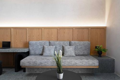 a couch sitting in a room with a table at La Torretta Suites & Spa in Pirgos