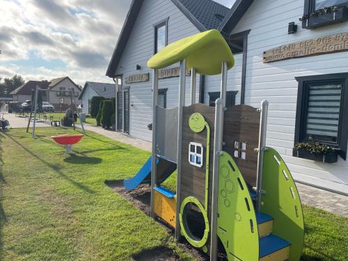 a playground with a slide in a yard at Amelia Resort in Sianozety
