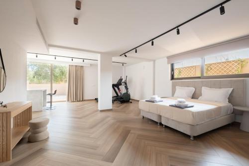 a white bedroom with a large bed and a desk at Villa Neratzia-Luxury Escape in Nerianá