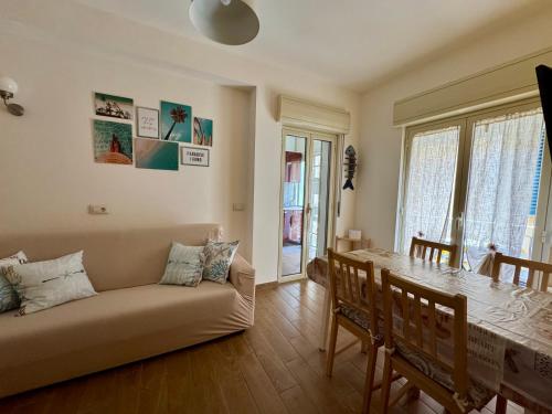 a living room with a couch and a table at Casa Antonella - Taormina mare in Mazzeo