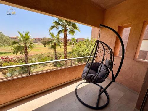 a swing in a room with a window at Appartement Prestigia Agate résidence avec piscine in Marrakech