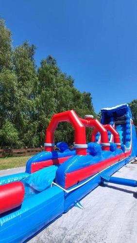 a blue and red water slide in a park at Sosnowy Domek Parter Zator Graboszyce in Graboszyce