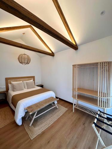 a bedroom with a bed and a chair in it at Balarés Hotel da Natureza in Ponteceso