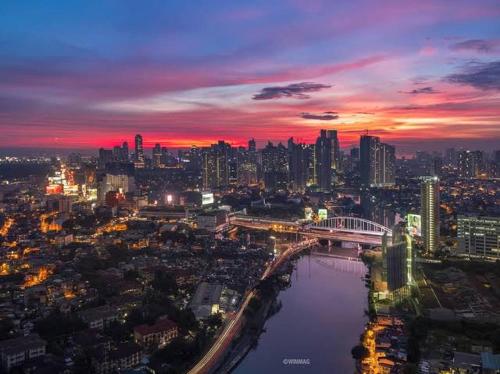 a city skyline at night with a river and a bridge at Welcome to Casa Sheridan Your cozy escape in the heart of the metro Whet in Manila