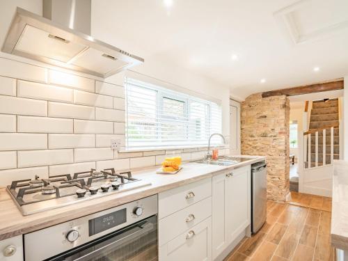 a kitchen with a stove and a sink at Stonegarth in Snitterby