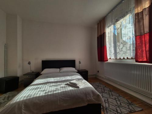 a bedroom with a large bed and a window at La Nelutu Ceterasu in Ocna Şugatag