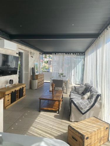 a living room with a couch and a table at PhilHouse, Jacuzzi Seaview & Bbq in Sanremo