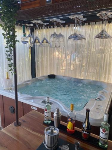 a bath tub with bottles of wine in it at PhilHouse, Jacuzzi Seaview & Bbq in Sanremo