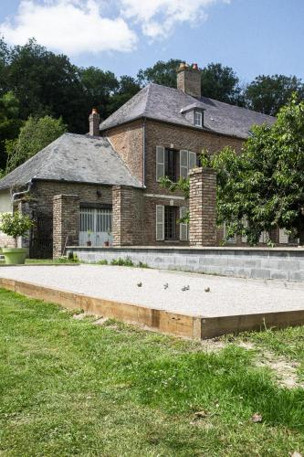 a large brick house with a large driveway at Le Cocon - Domaine du Colombier in Vaux-Marquenneville