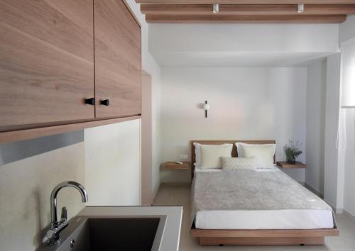 a small bedroom with a bed and a sink at Swell Living Double Room in Asprovalta
