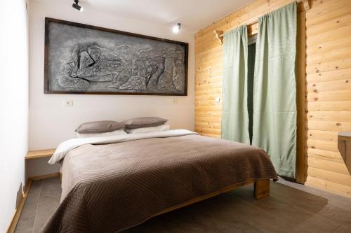 a bedroom with a bed and a painting on the wall at Villa Wellness in Debar