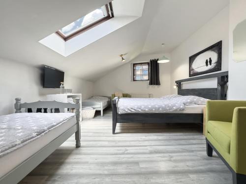 a bedroom with two beds and a skylight at Apartmán Vikárka - dům Karla Hynka Máchy - Litoměřice in Litoměřice