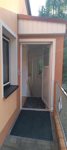 an open door of a house with a balcony at FeWo Giehl in Burgebrach