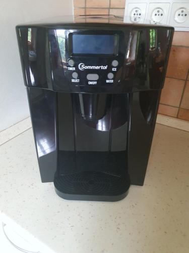 a black coffee maker sitting on top of a counter at Chata Hermann - Vernířovice in Vernířovice
