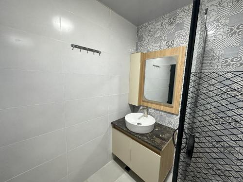 a bathroom with a sink and a mirror at Iliaseuli's Cottage in K'vemo Jocho