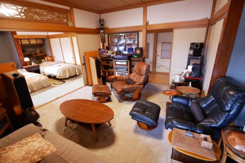 a living room filled with furniture and a bedroom at Natural Mind Tour guest house - Vacation STAY 23273v in Sado