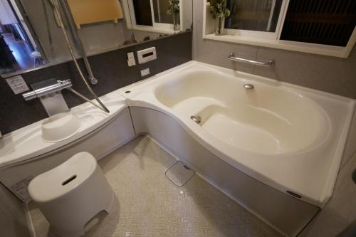 a bathroom with a white tub and a toilet at Natural Mind Tour guest house - Vacation STAY 23273v in Sado