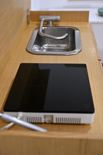 a tablet sitting on a counter next to a sink at Domus Cassino Centro in Cassino