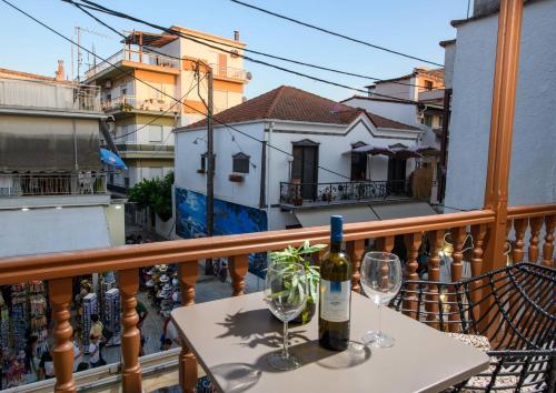 a table with two glasses and a bottle of wine on a balcony at Sea View Center in Limenas