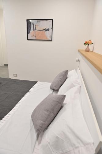 a white bed with two pillows on top of it at Domus Cassino Centro in Cassino