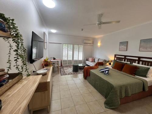 a living room with a bed and a couch at Salty waves - D246 in Port Douglas