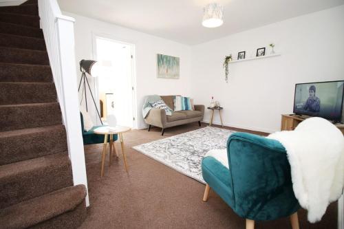 a living room with two chairs and a couch at Gwent View by Tŷ SA in Newport