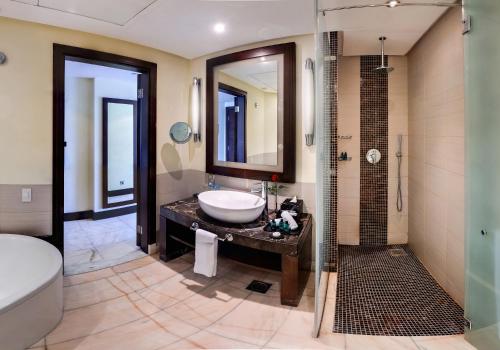a bathroom with a sink and a shower at Sofitel Al Khobar The Corniche in Al Khobar