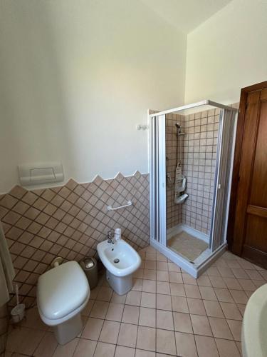 a bathroom with a toilet and a shower and a sink at Adelina House in Olbia
