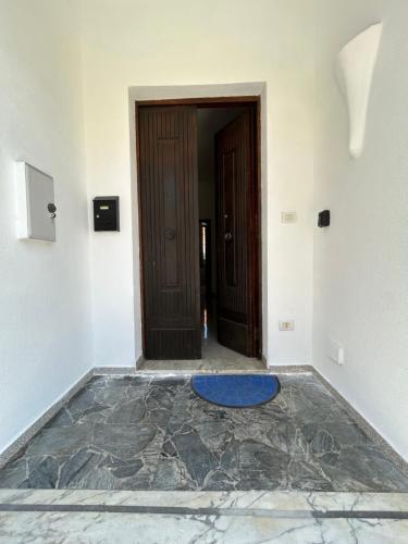 an empty room with a door and a blue rug at Adelina House in Olbia