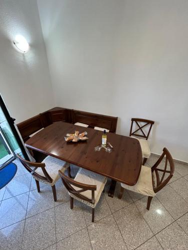 a wooden table and chairs in a room at Adelina House in Olbia