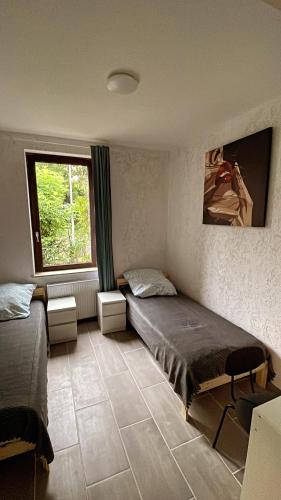 a bedroom with two beds and a window at Appartment Сoppenbrügge in Coppenbrügge