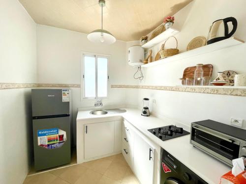 a small kitchen with a refrigerator and a sink at Chic Design Stay With a Chocolate Welcome Gift in Agadir