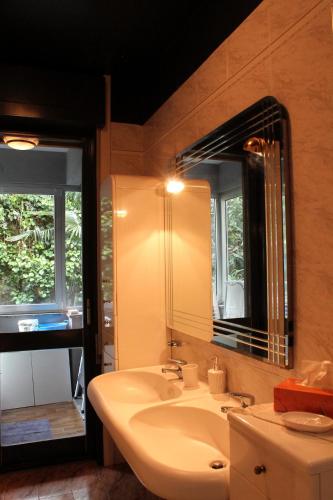 a bathroom with a sink and a mirror at COLOR HOUSE- Lecco's Lake in Lecco