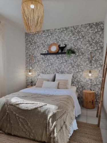 a bedroom with a large bed and a wall at Maison cocon Bali in Saint-Pierre-des-Corps