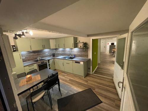 a kitchen with a table and a dining room at Haus Delphinen in Lübben