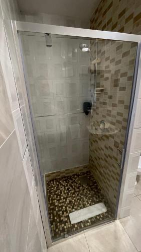 a shower with a glass door in a bathroom at SeaClusion Barna in Barna
