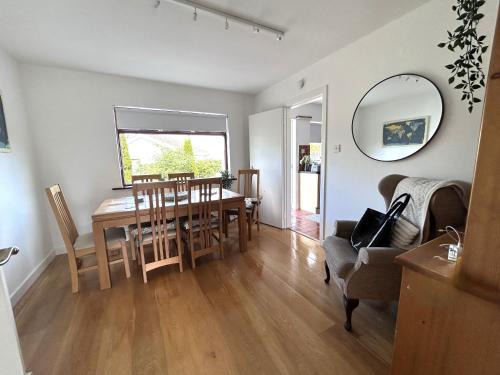 a kitchen and dining room with a table and chairs at THE VILLAGE HOUSE on Wild Atlantic Way CLARINBRIDGE VILLAGE in Galway