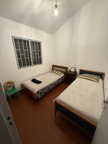 a room with two beds and a window at Departamento en Salta Capital in Salta