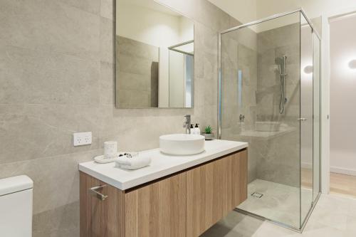 a bathroom with a sink and a shower at Hamilton By the Bay 3 Newly Built in Safety Beach