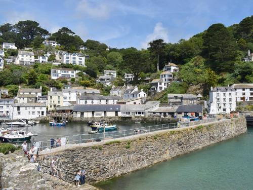 a group of people standing on a bridge over a river at The Wee Cottage in Polperro
