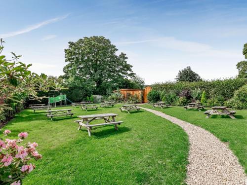 a park with picnic tables in the grass at Fioled - Uk40267 in Llangadfan