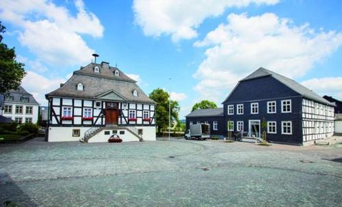 a large building with a black and white at Fewo Meschede Eversberg Radring in Meschede