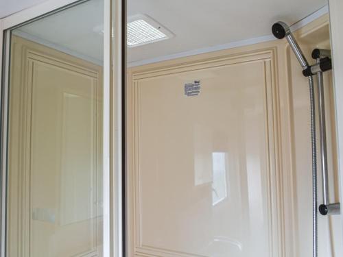 a shower with a glass door in a bathroom at Methlem in Aberdaron