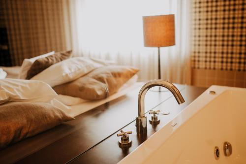 a bathroom with a sink and pillows on a table at Hotel Wawrzyniak in Zduny